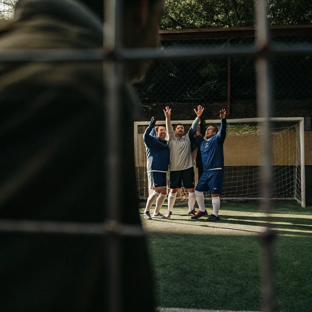 Football players celebrating a goal together