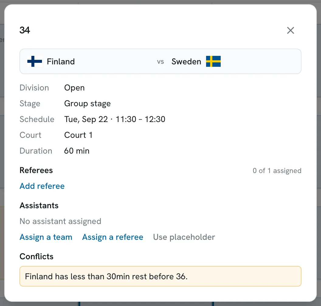 A game's detail panel in Scored, showing the division, stage, court, duration, referee and assistant assignment, and a conflict warning that Finland has less than 30 minutes of rest before its next game