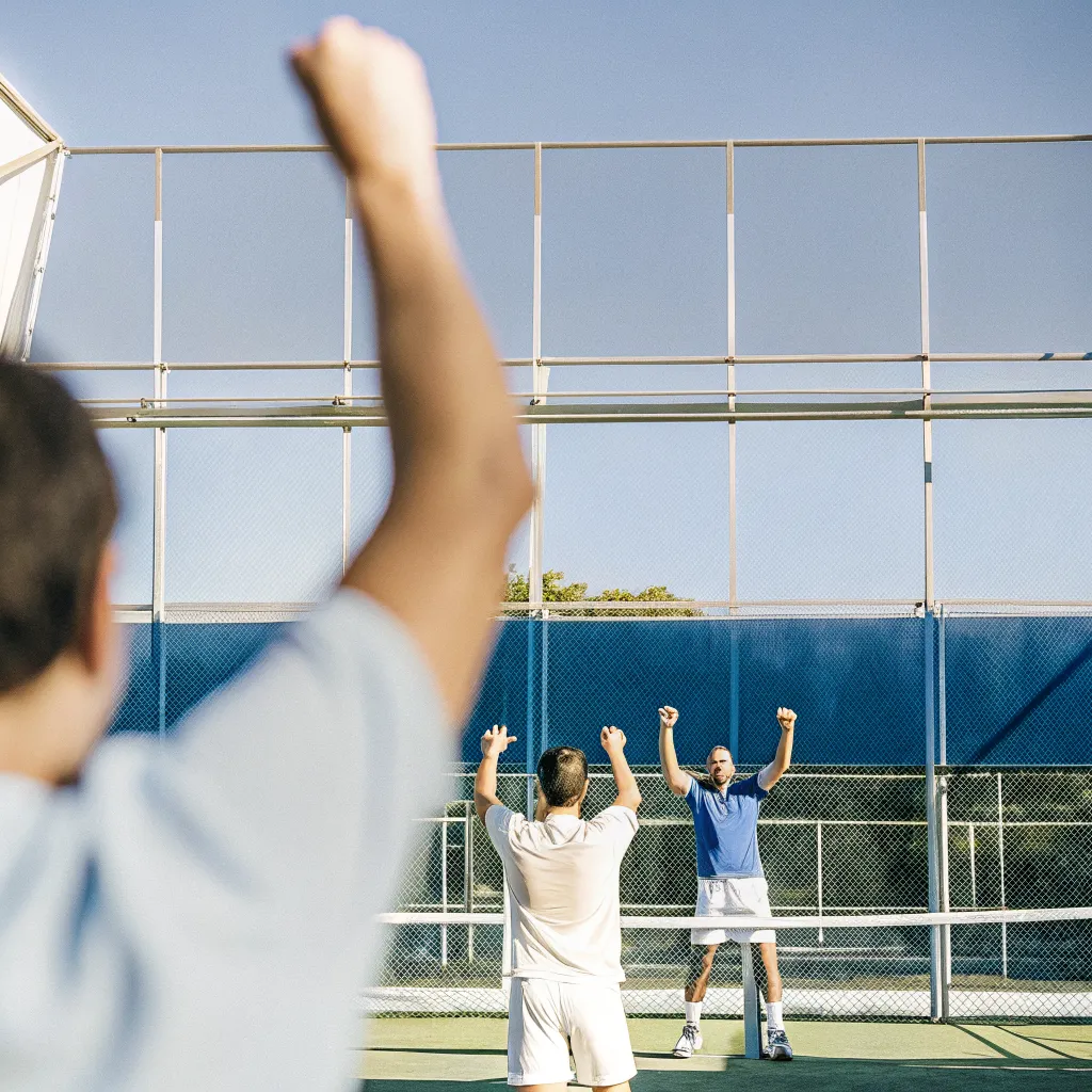 Padel players celebrating a winning point